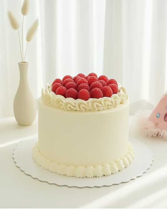 White cake with raspberries and whipped ganache